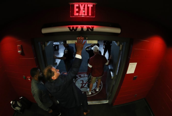 Nick Saban hits the Alabama "Win" bar above the locker room door